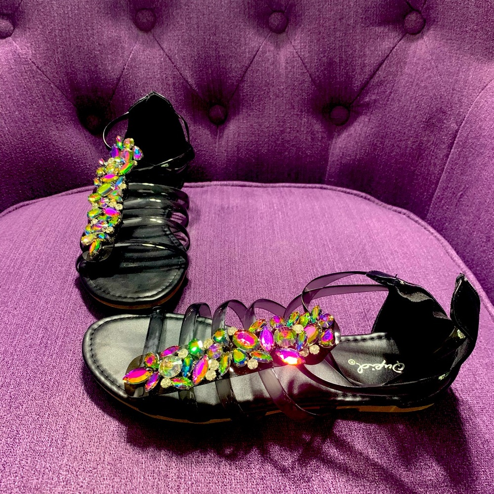 Plastic strappy embellished with multi colored crystals. Flat